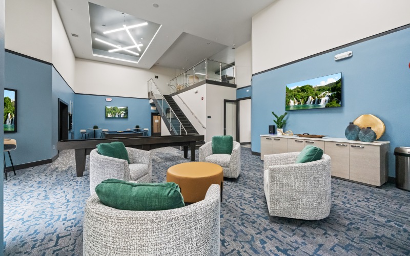 spacious lounge room with shuflle-board, seating and modern decor